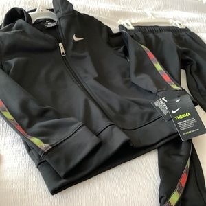 Brand New, Boys Black Nike suit with colorful trim down arms and legs says Nike